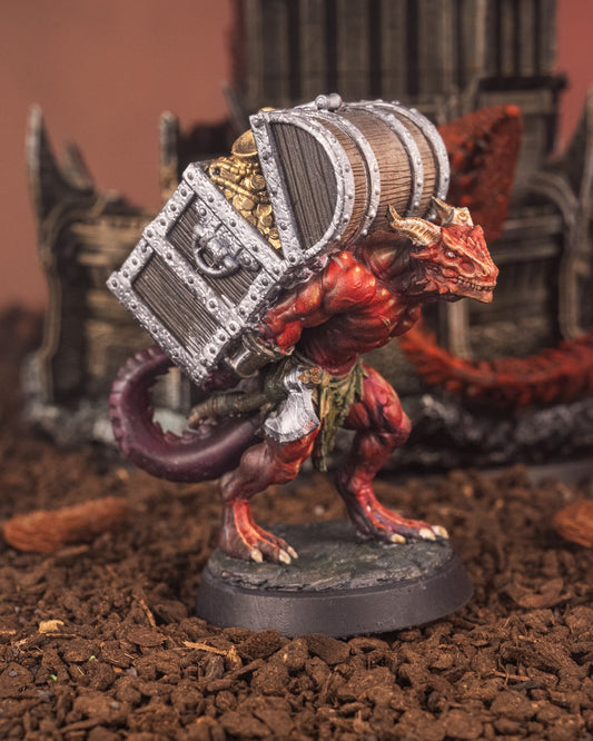 Painted Dragonfolk Carrier miniature depicted as a treasure bearer, scales and horns visible under heavy chests, posed on rocky base, perfect for fantasy RPG NPC encounters.