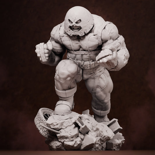Front view of unpainted Juggernaut collectible figure in mid-stride atop rubble and tire debris, fists clenched and helmeted head snarling forward.