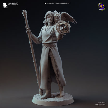 Grey render front view of Gale 1:8 scale collectible standing on rocky base with staff in left hand and spell glyph in right, Tara perched on his shoulder.