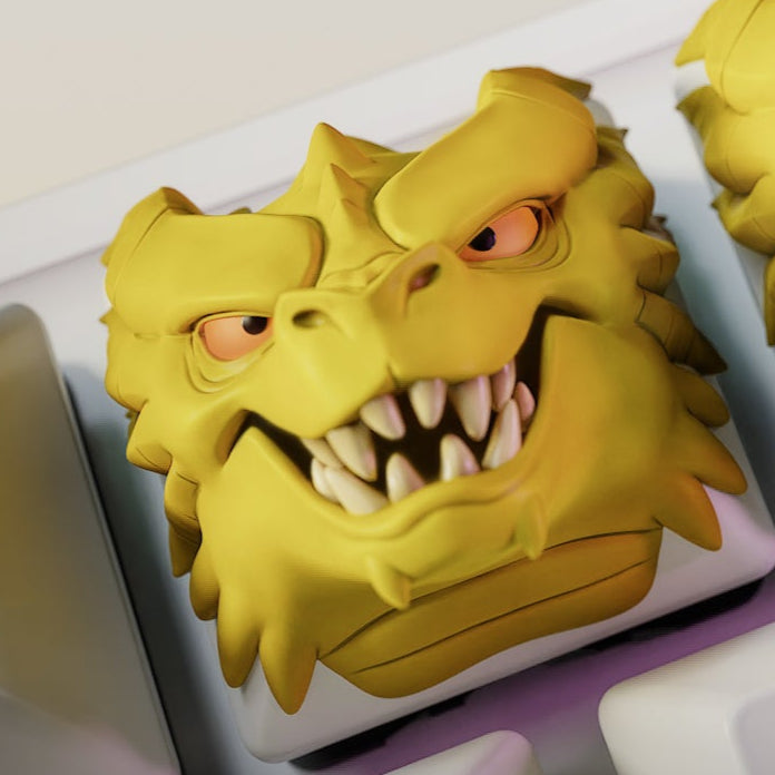 Ferocious dragon head artisan keycap with snarling teeth and angry eyes on a mechanical keyboard key