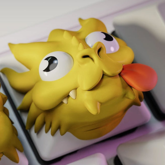 Derpy dragon head artisan keycap with silly wide eyes and tongue sticking out on a mechanical keyboard key