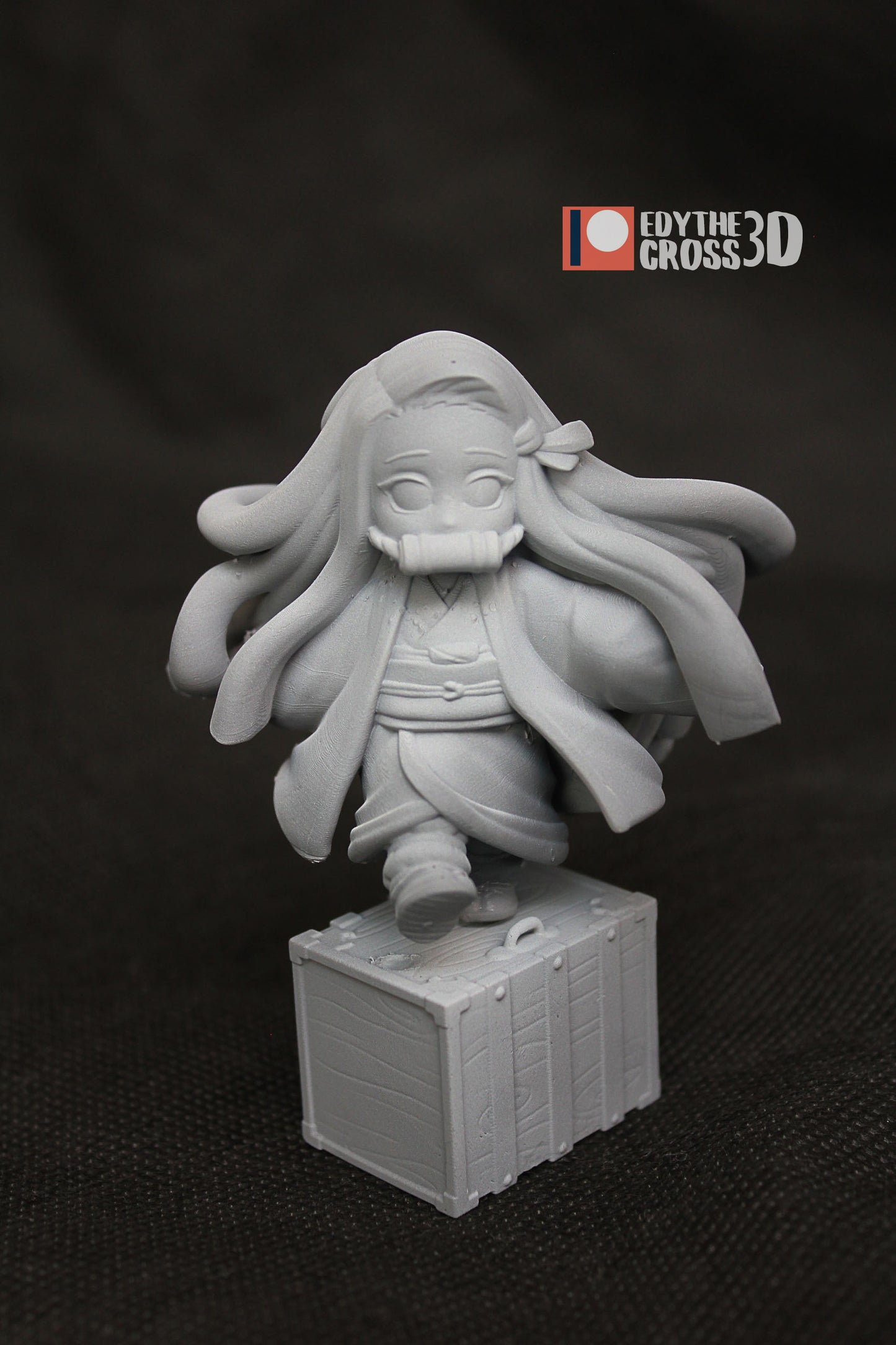  Unpainted Chibi Nezuko miniature showing detailed sculpting and her iconic box platform, ready for display or painting.