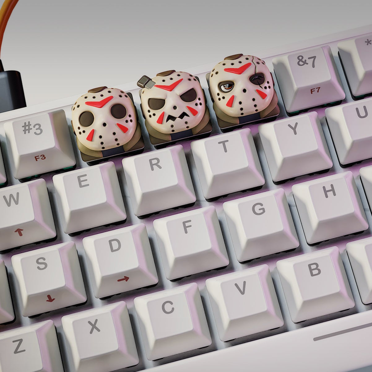 Jason Voorhees Halloween keycaps on a mechanical keyboard, featuring three versions of the masked horror icon – NomNom Figures collectible keycap set.
