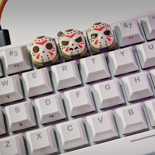 Jason Voorhees Halloween keycaps on a mechanical keyboard, featuring three versions of the masked horror icon – NomNom Figures collectible keycap set.