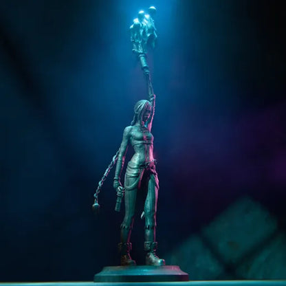 Full-body figurine of Jinx from League of Legends, standing with a mischievous smirk, braided hair, and holding her iconic weapon.