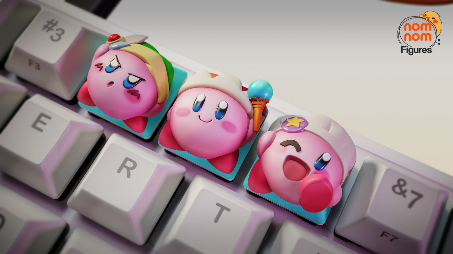 Kirby artisan keyboard keycaps set featuring sword Kirby, classic Kirby, and winking star Kirby installed on a mechanical keyboard