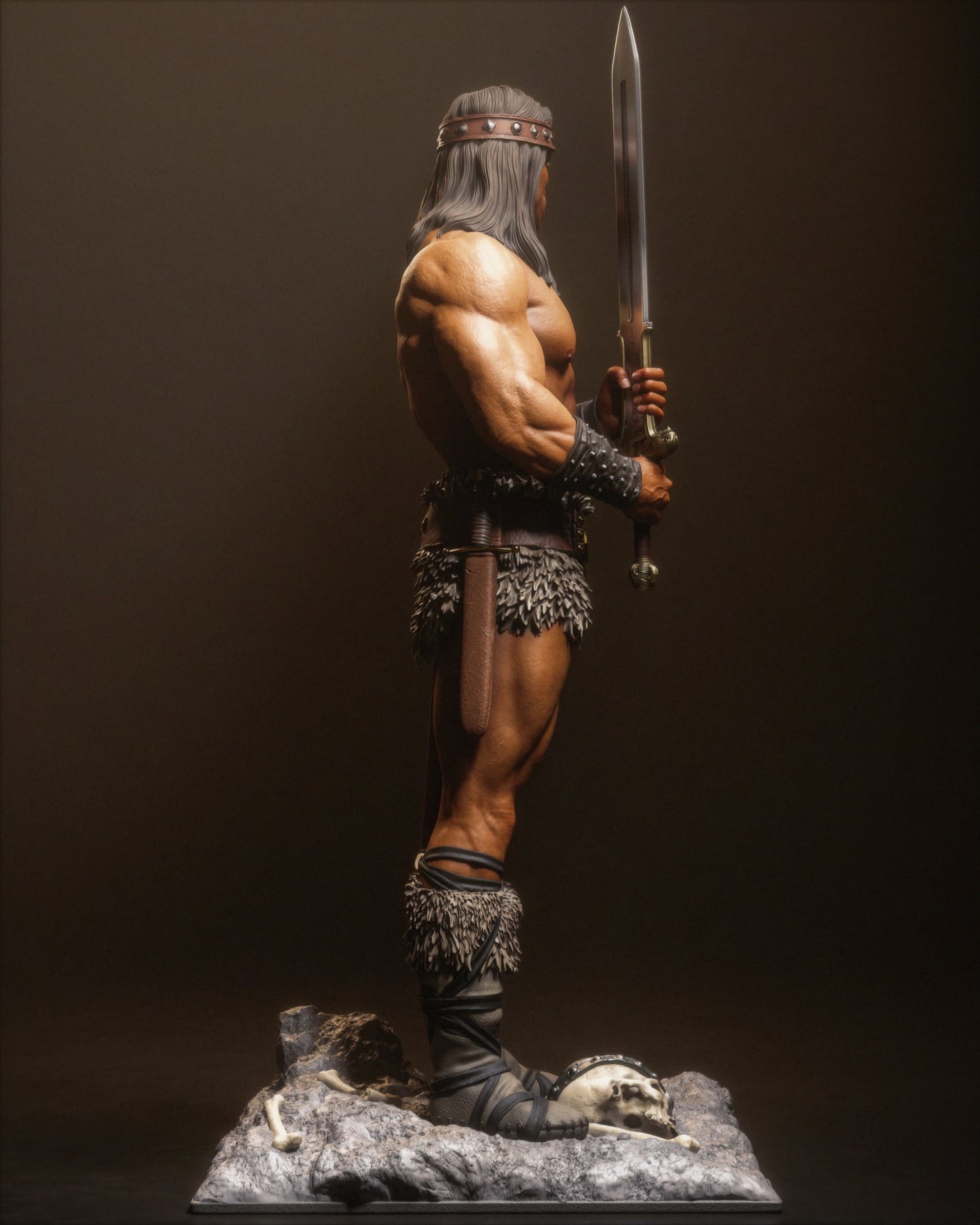 Right side view of Conan statue showing leg armor, sword hilt, and standing over a rocky base with bones.