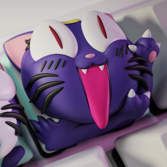 Close-up of the Mischievous Luna keycap from Sailor Moon, depicting the purple cat with sharp teeth, slanted playful eyes, and crescent moon detail on her forehead.