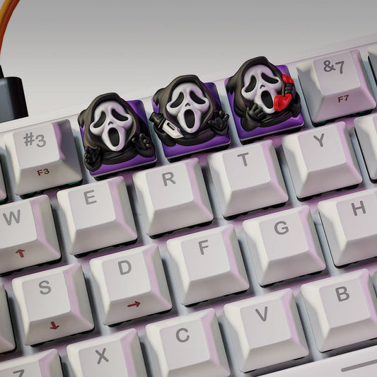 Ghostface Halloween keycaps on mechanical keyboard featuring three variations of the iconic masked killer – NomNom Figures collectible keycap set.