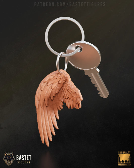 Sephiroth-inspired keychain featuring a detailed sculpt of his iconic wing from Final Fantasy VII, attached to a silver keyring with a standard house key.