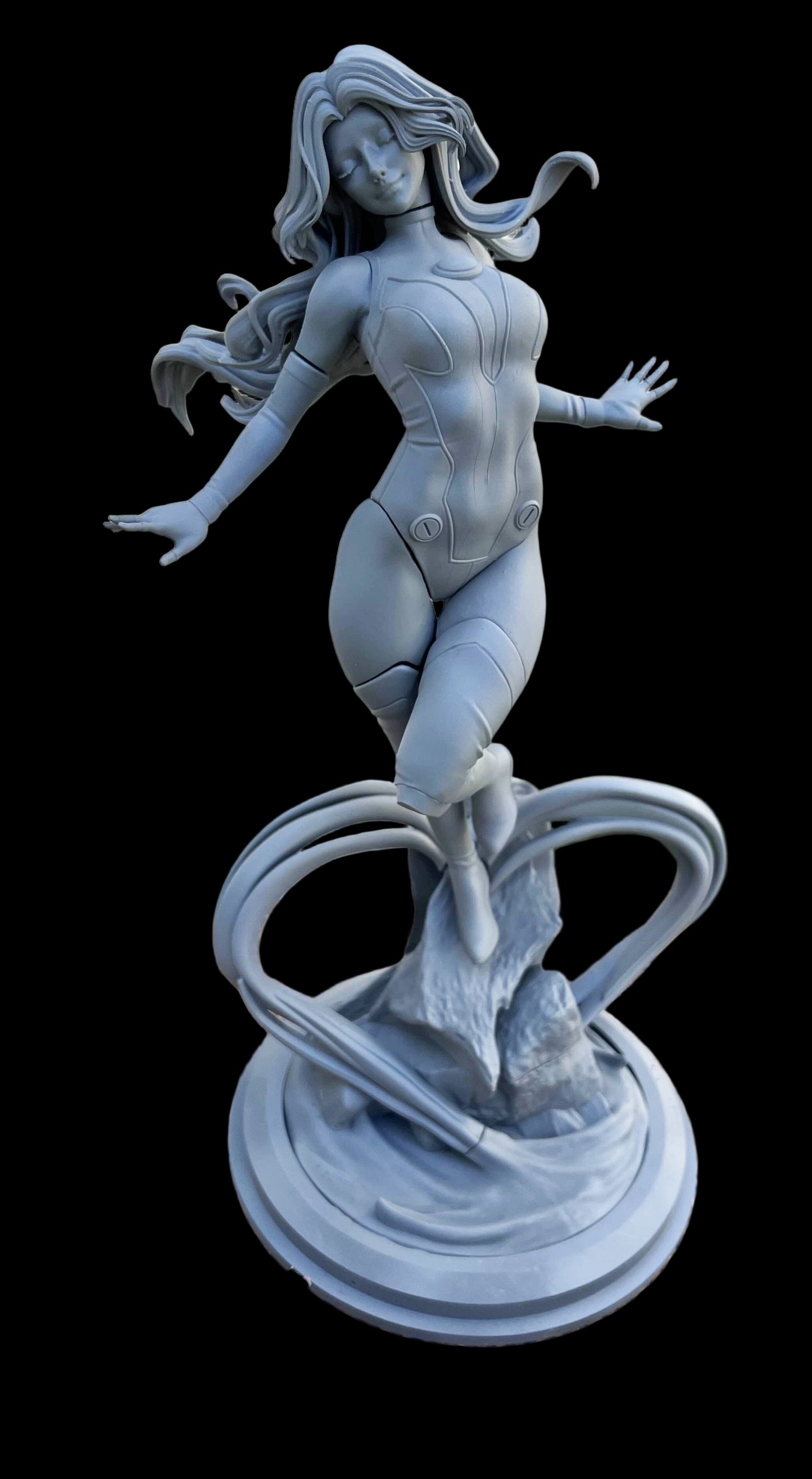 Starfire 1:6 scale statue gray prototype shown assembled with flowing hair, bodysuit detail, rock base, and energy-loop effects; DC Comics collectible model.