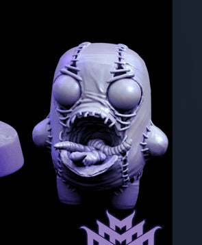 A small stitched figure with wide-open mouth filled with crawling worms. Its stitched details and eerie expression suit a horror-themed role-playing scenario.