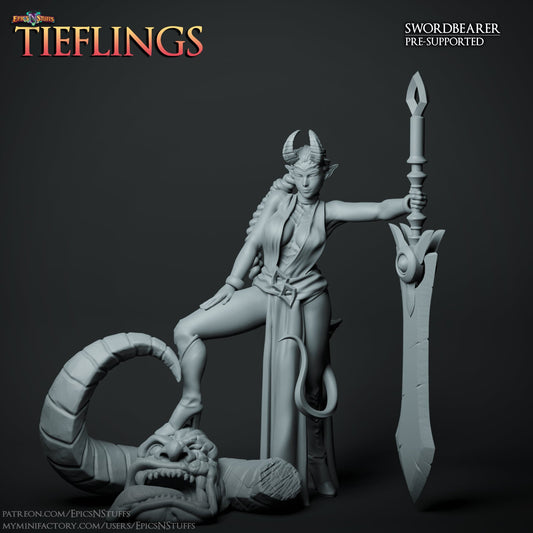 A Tiefling Swordbearer miniature is shown in a confident pose, with one foot on a severed demonic head and her large sword resting against her shoulder. She has horns, a tail, and a commanding expression, dressed in flowing garments.