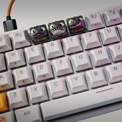 Toothless keyboard keycap set showing three faces including a happy grin, fish in mouth, and licking lips on a white keyboard.