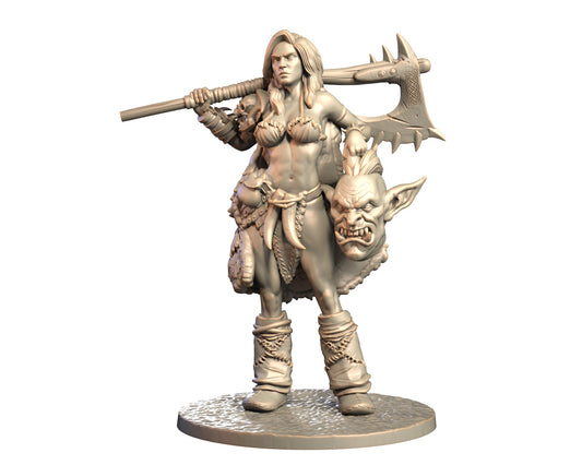 Ulrakka female human barbarian miniature with massive axe resting across shoulders and orc trophy head at side.