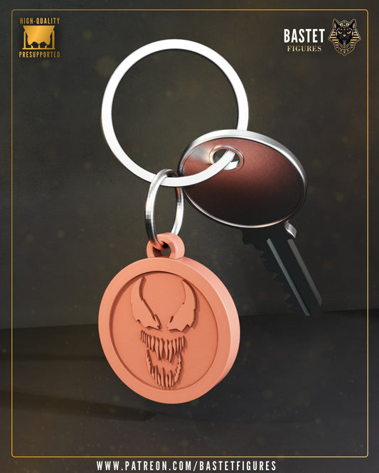 Venom emblem keychain featuring the character’s jagged grin and stylized eyes engraved on a circular medallion, attached to a silver keyring with standard keys, designed by Bastet Figures.