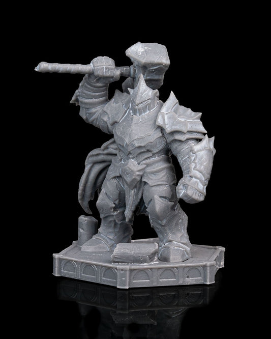 Front view of unpainted Warden Golem miniature in full plate armor, holding a large hammer over its shoulder, standing on a ruined temple base.