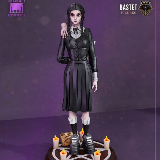 Painted Wednesday Addams statue front view showing black dress, braids, and eerie candlelit base.