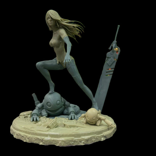 Unpainted prototype of A2 on a detailed base with stubby bots, placed in front of a game-themed background.