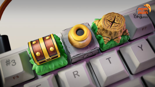 closeup of zelda themed treasure chest keycap pot keycap and tree stump seal keycap mounted on mechanical keyboard for gamers and collectors