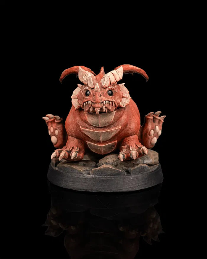 Young red dragon creature miniature front view from Beldrad's Bag of Beasts with chubby body, curled horns, stubby wings, seated pose, and exaggerated proportions inspired by Themberchaud from Dungeons & Dragons Honor Among Thieves