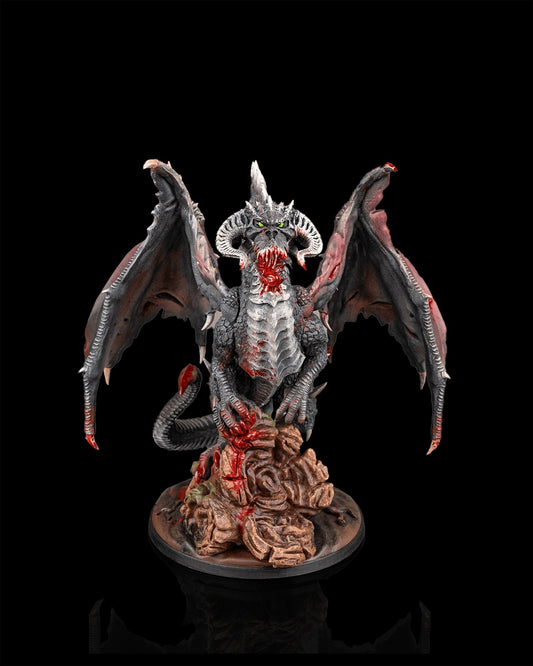 Painted black dragon miniature front view from Beldrad's Bag of Beasts with wings extended, horned head, clawed hands gripping rock base, ancient black dragon monster suitable for Dungeons & Dragons and Pathfinder campaigns
