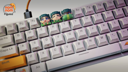 Full view of a mechanical keyboard featuring three Maomao keycaps above the E, R, and T keys, showcasing colorful collectible keycaps on an otherwise white keyboard setup.