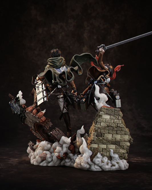 Rear view of Mikasa and Levi 1:6 scale Attack on Titan diorama featuring flowing cloaks, maneuver gear canisters, twin blades, and collapsing rooftop environment