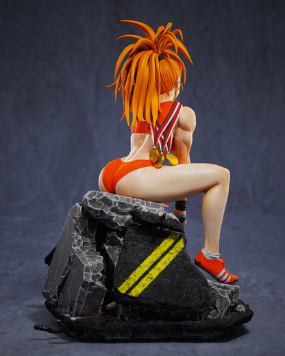 Rear view of Captain Mizuki statue seated on rubble base with yellow stripes, showing her athletic build and medals.