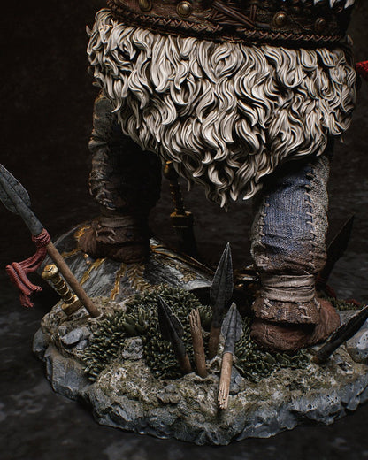 Detailed shot of the base featuring intricate elements like shattered shields, swords, and lush grass beneath Obelix's feet.