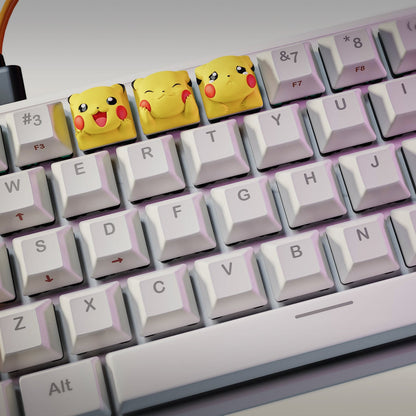 Wide shot of keyboard with three Pikachu keycaps replacing standard keys near top row
