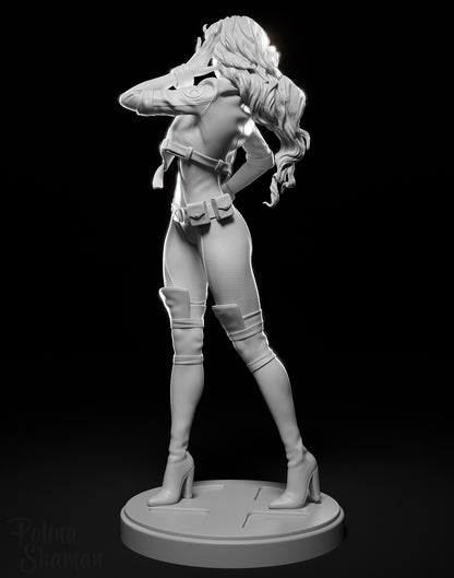 Rear grayscale view of Rogue showing her textured suit, long flowing hair, and utility belt.

