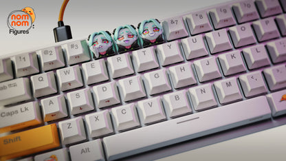 Angled view of Rebecca keycaps with pastel lighting on a mechanical keyboard, showing her iconic expressions.