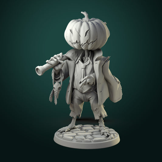 Scarecrow miniature with carved pumpkin head, tattered coat, and twisted staff standing on cobblestone base.
