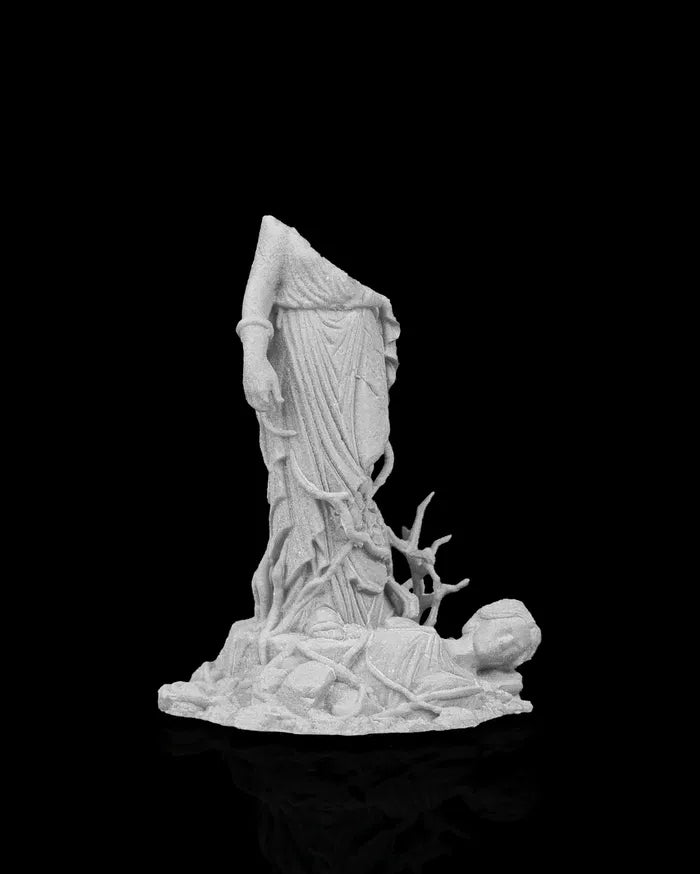Broken stone statue remains partially buried in rubble, ancient ruin scatter terrain piece